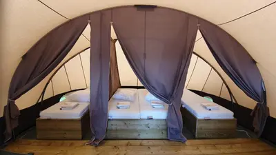 a couple of beds in a tent at Glamping at the water, close to Amsterdam in Aalsmeer
