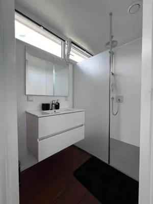 a bathroom with a sink and a shower at Oktopus-Lofts - Houseboat in Lelystad
