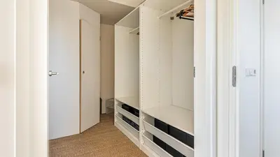 a walk in closet with white closets at Villa Sea breeze in Bergen aan Zee