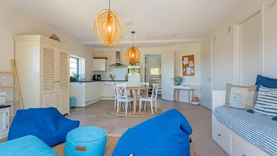 a living room with a couch and a table at Villa Sea breeze in Bergen aan Zee