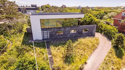 an aerial view of a black and white house at Villa Sea breeze in Bergen aan Zee