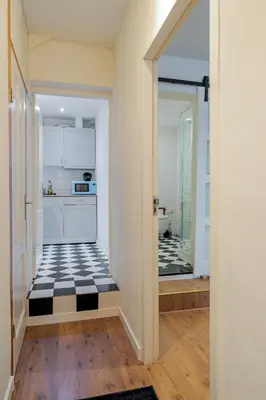 a kitchen with a black and white checkerboard floor at Suite with private bathroom near Vondelpark in Amsterdam