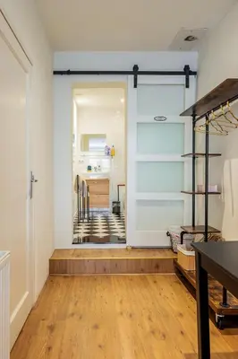 a room with a sliding glass door leading to a kitchen at Suite with private bathroom near Vondelpark in Amsterdam