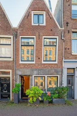 a brick building with windows on a street at Suite with private bathroom near Vondelpark in Amsterdam