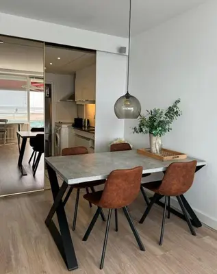 a dining room table with chairs and a kitchen at Blue Fish in Zandvoort