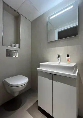 a bathroom with a white sink and a toilet at Blue Fish in Zandvoort