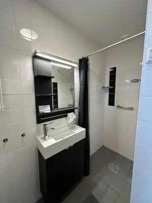 a bathroom with a sink and a mirror at De Schelp 86, Garden and Free parking in Zandvoort