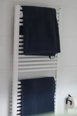 a towel rack with blue towels on it at Studio Jordaan Amsterdam City Centre in Amsterdam