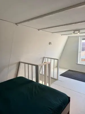 a room with a bed and a staircase in it at Studio Jordaan Amsterdam City Centre in Amsterdam