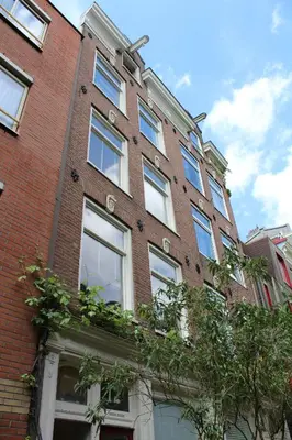 a brick building with windows on the side of it at Studio Jordaan Amsterdam City Centre in Amsterdam