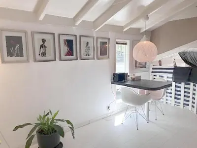 a dining room with a table and a potted plant at Bed and breakfast private accommodation at Amsterdam Houseboat in Amsterdam