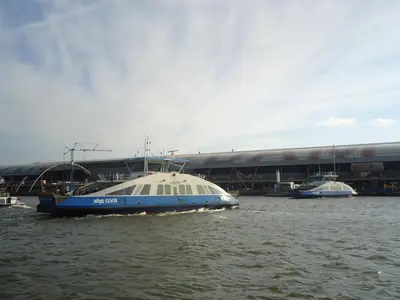 a blue and white boat in a body of water at Bed and breakfast private accommodation at Amsterdam Houseboat in Amsterdam