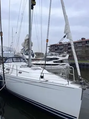 a white boat is docked in the water at Bed and breakfast private accommodation at Amsterdam Houseboat in Amsterdam
