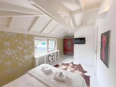 a bedroom with a bed and a tv in it at Bed and breakfast private accommodation at Amsterdam Houseboat in Amsterdam