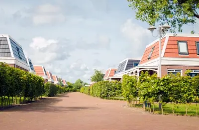 a street in a city with buildings and trees at Tulp en Zee in Noordwijk