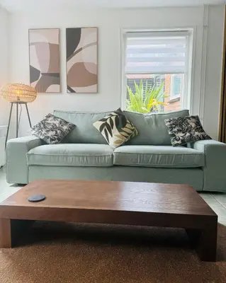 a living room with a couch and a coffee table at Beachhouse De Dahlia in Noordwijk aan Zee