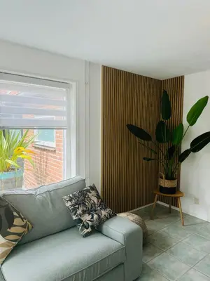 a living room with a couch and a window at Beachhouse De Dahlia in Noordwijk aan Zee