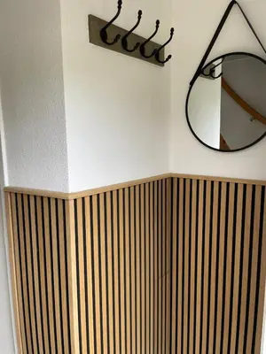 a bathroom with a mirror and a wooden radiator at Beachhouse De Dahlia in Noordwijk aan Zee