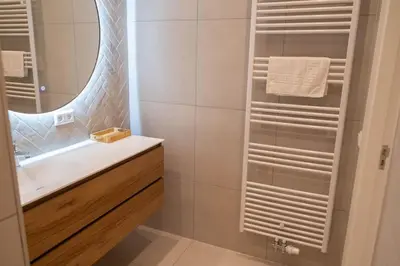 a bathroom with a sink and a mirror at Sint Adelbertus in Egmond-Binnen