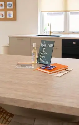 a kitchen counter with a welcome sign on a table at Sint Adelbertus in Egmond-Binnen