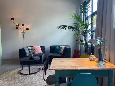 a living room with a table and a couch at M&M guest house in Amsterdam