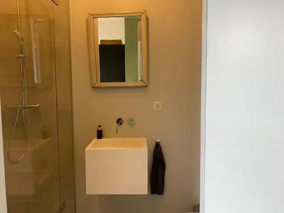 a bathroom with a sink and a shower at M&M guest house in Amsterdam