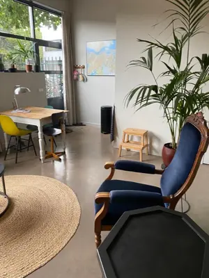 a room with chairs and a table and a plant at M&M guest house in Amsterdam