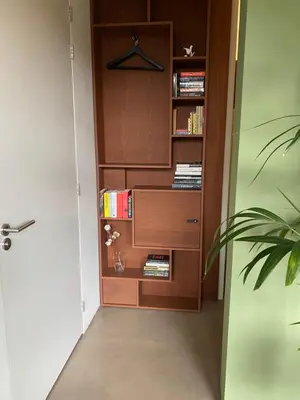 a room with a book shelf with books at M&M guest house in Amsterdam