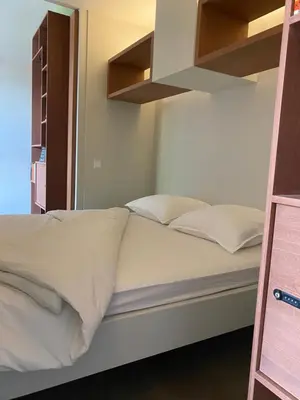 a bed with white sheets and pillows in a room at M&M guest house in Amsterdam