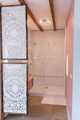 a shower with a glass door in a bathroom at Ben bij Bos in Oude-Niedorp