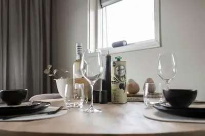 a table with glasses and a bottle of wine at Loft 48 in Haastrecht