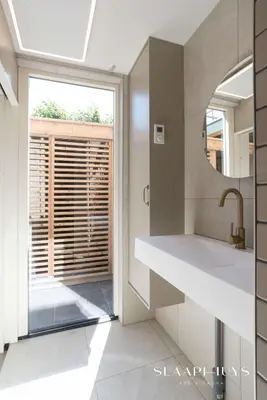 a kitchen with a sink and a window at Slaaphuys Bed & Sauna in Alkmaar