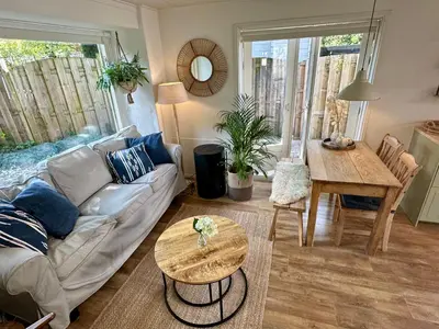 a living room with a couch and a table at Vakantiehuis Flori in Bergen