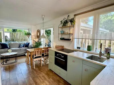 a kitchen with a sink and a stove top oven at Vakantiehuis Flori in Bergen