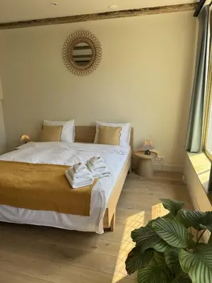 a bedroom with a bed with towels on it at The Hazel House in Haarlem