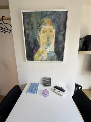 a white table with a painting on the wall at The Hazel House in Haarlem