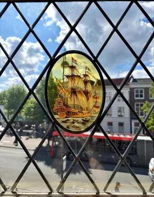 a mirror on a window with a ship on it at The Hazel House in Haarlem