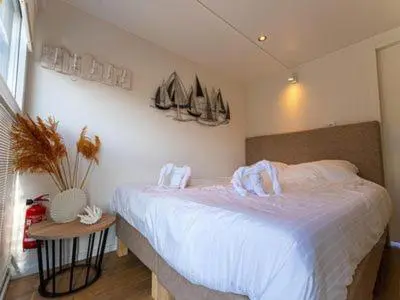 a bedroom with a bed with sails on the wall at Houseboat Tomio near Amsterdam in Monnickendam