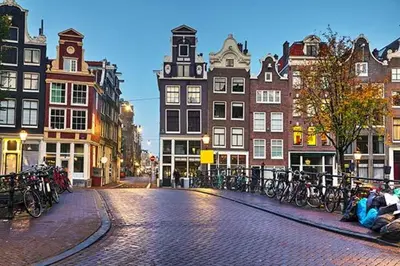 a cobblestone street in a city with buildings and bicycles at Houseboat Tomio near Amsterdam in Monnickendam