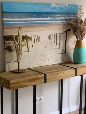 a wooden shelf with a picture of a beach at Appartement Meer-C in Zandvoort