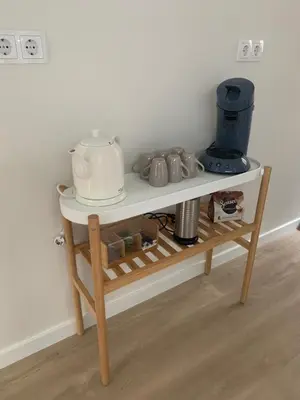a small white table with a coffee maker on it at Appartement Meer-C in Zandvoort