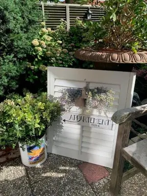 a white door with potted plants in a garden at Appartement Meer-C in Zandvoort