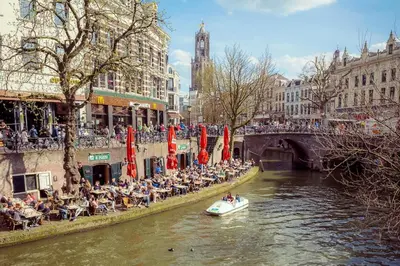 a group of people riding a boat down a river at Suite Canalhouse Majestic in Utrecht