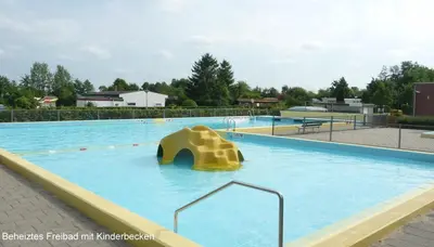 a large swimming pool with a slide in the water at Bungalowpark in Nordholland in Opmeer