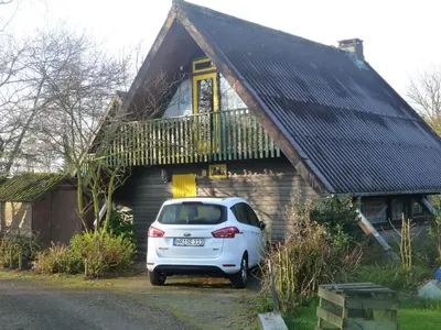 a white car parked in front of a house at Bungalowpark in Nordholland in Opmeer