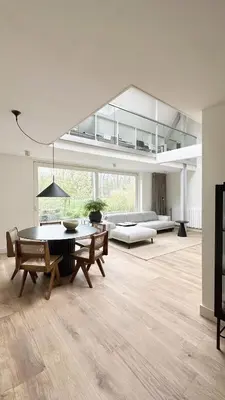 a large living room with a table and chairs at Luxury spacious private loft, between city & beach in Heemstede