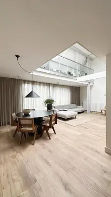 a living room with a table and a couch at Luxury spacious private loft, between city & beach in Heemstede