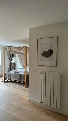 a white room with a bed and a mirror at Luxury spacious private loft, between city & beach in Heemstede