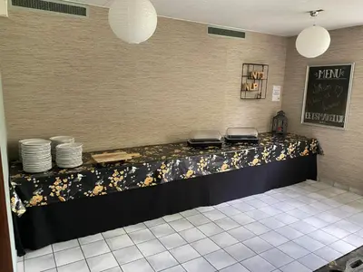a counter in a restaurant with plates on it at Het Huis van Bewustzijn in Limmen