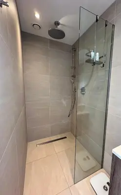 a shower with a glass door in a bathroom at Pakhuis Prins in Zaandam